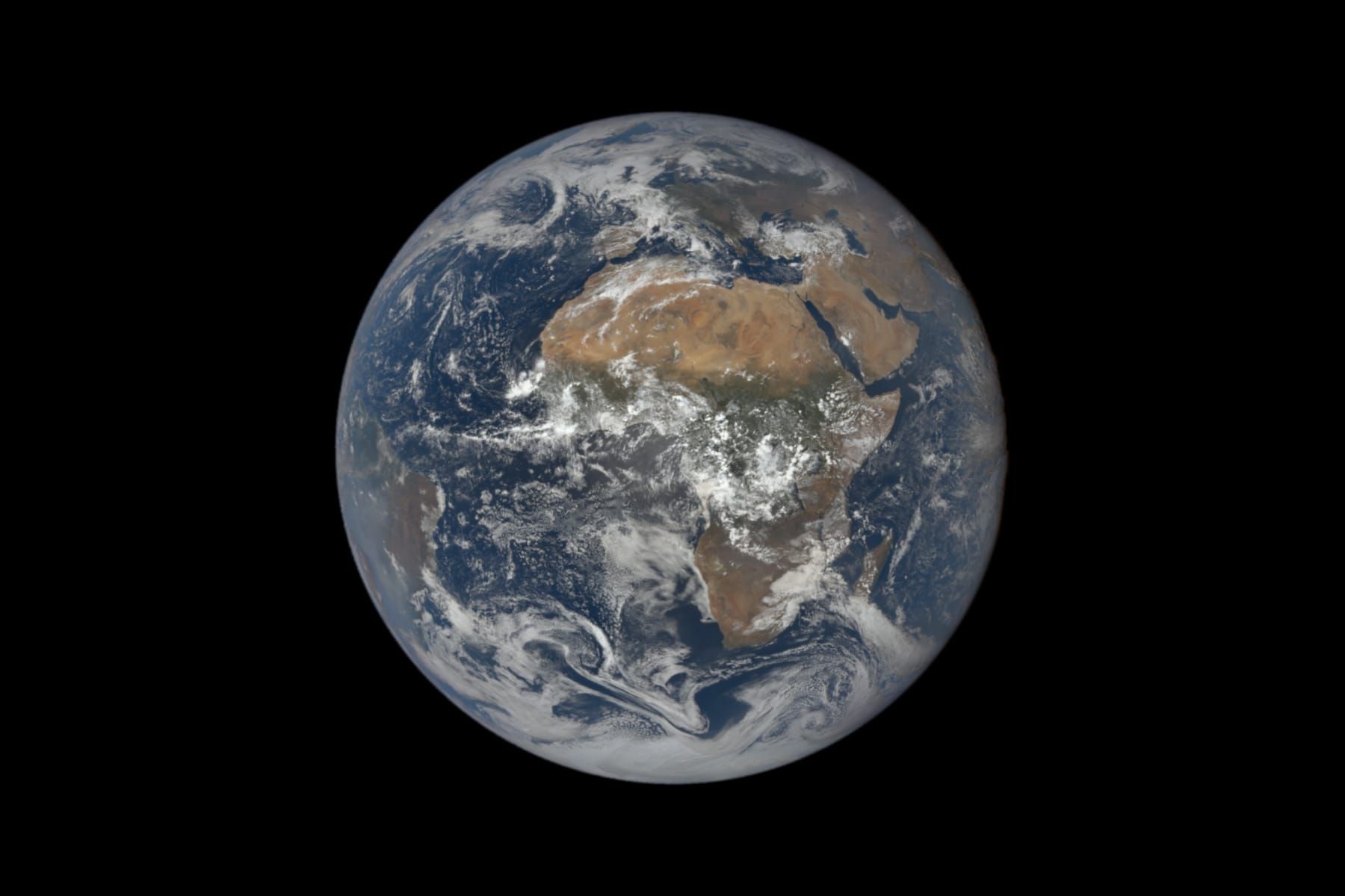 Full disc of Earth seen from space, centred on Africa and the Atlantic, with both poles near the edge